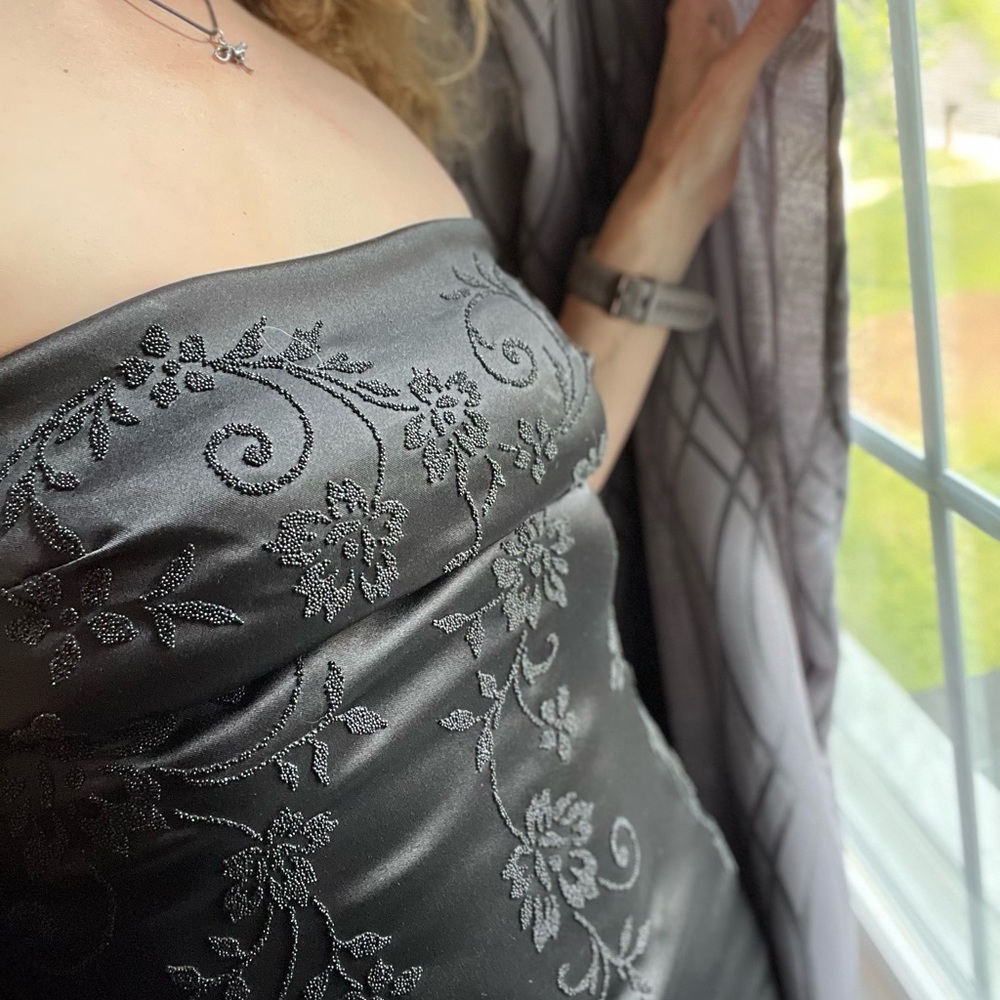 Strapless black dress with elegant flourish/details
